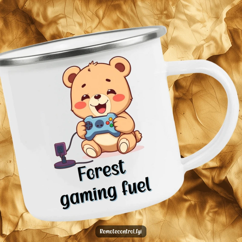 Funny camping mug with a delighted bear cub playing video games by a campfire, remote in paw, for outdoor fun.