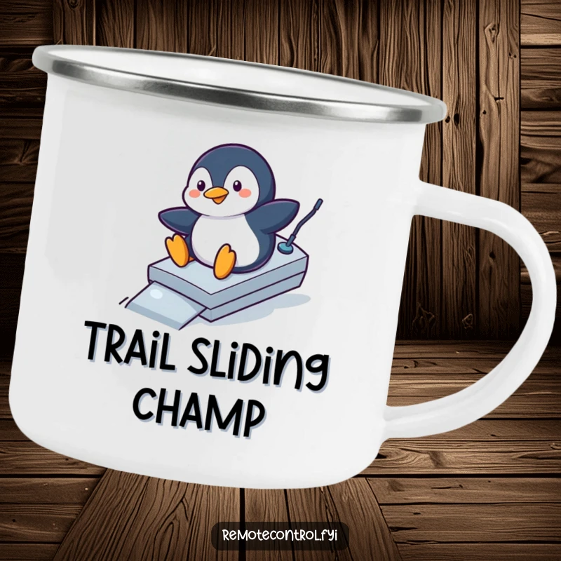 Funny penguin camping mug depicting a playful penguin sliding down a remote control like a ramp, a humorous outdoor accessory.