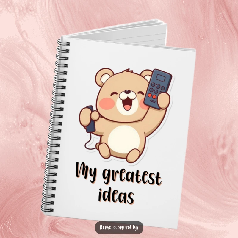 Funny notebook with a delighted bear character holding a remote control upside down, smiling. Perfect for journaling and ideas.